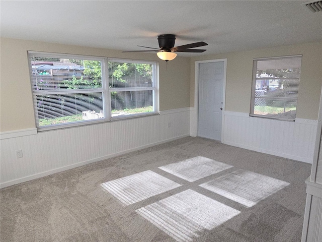 5130 Tilson Dr, New Port Richey, FL 34652 - carpeted spare room with a wainscoted wall, visible vents, and a ceiling fan
