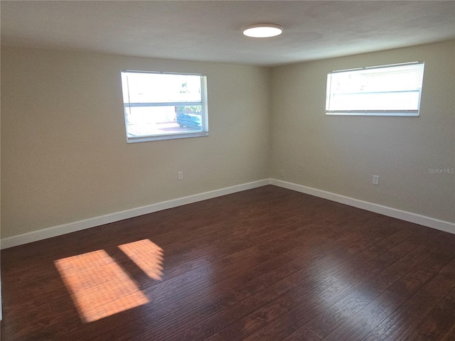 5130 Tilson Dr, New Port Richey, FL 34652 - empty room featuring baseboards and dark wood-style floors
