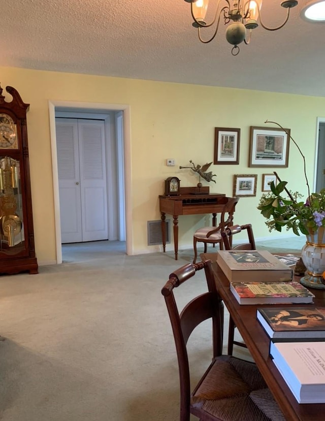 dining area with an inviting chandelier, a textured ceiling, light colored carpet, and visible vents