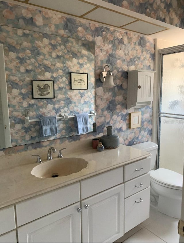 bathroom featuring wallpapered walls, vanity, toilet, and tile patterned flooring