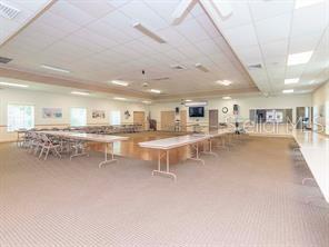 recreation room featuring visible vents, carpet floors, and a paneled ceiling