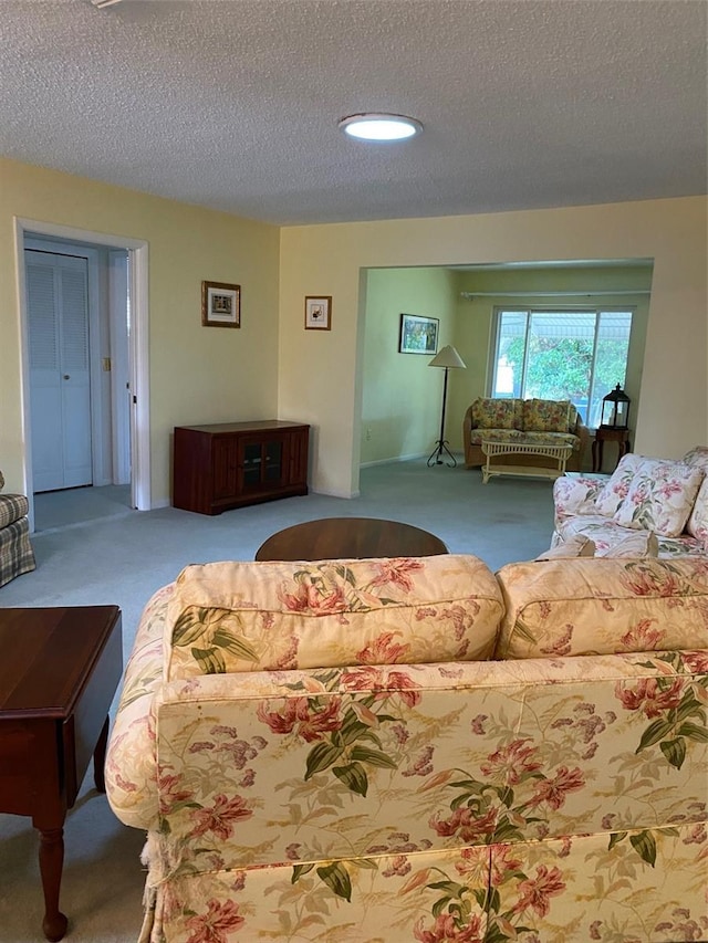 living room featuring carpet floors and a textured ceiling
