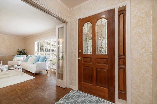 entrance foyer featuring wallpapered walls, ornamental molding, and baseboards