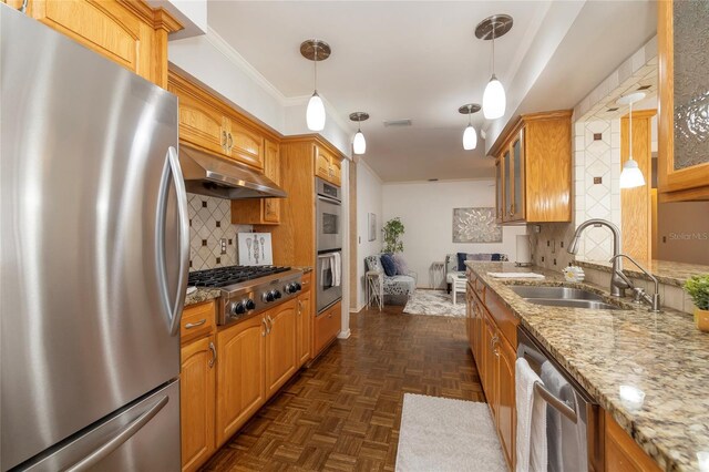 kitchen featuring stainless steel appliances, a sink, under cabinet range hood, glass insert cabinets, and light stone counters