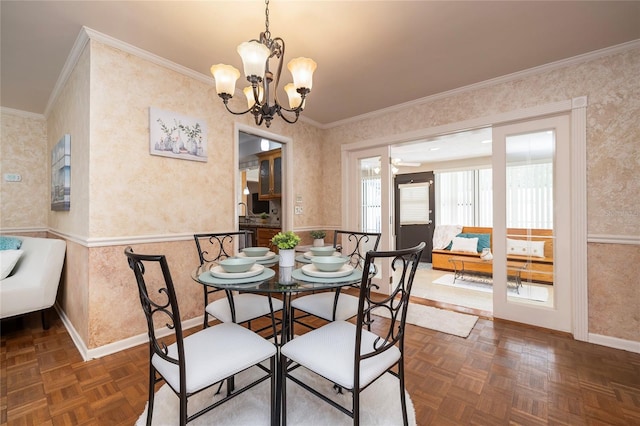 dining room featuring wallpapered walls, baseboards, a chandelier, and ornamental molding