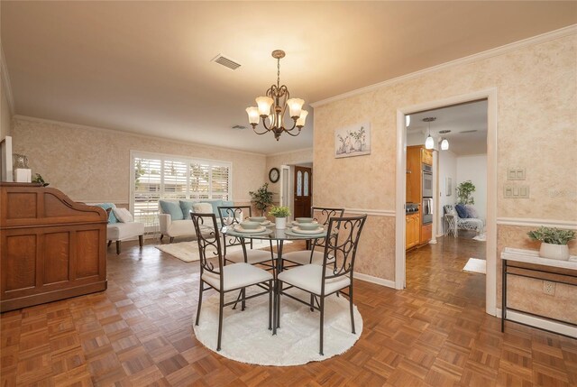 dining area with wallpapered walls, a chandelier, ornamental molding, and baseboards