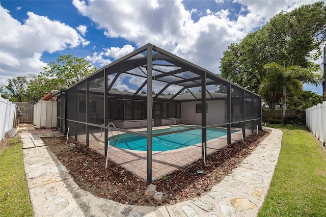 view of swimming pool featuring a patio area and a lanai