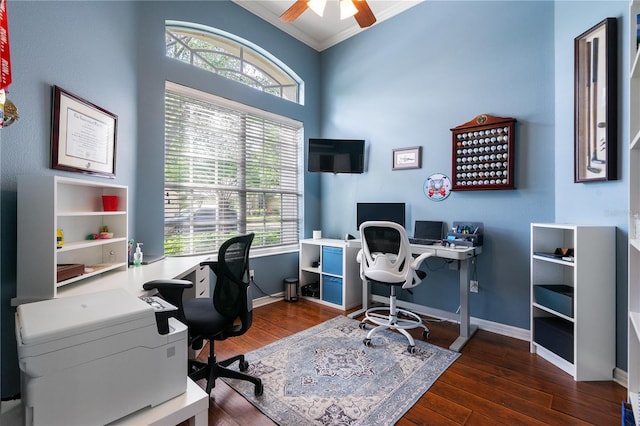 office space featuring baseboards, dark wood-style flooring, ornamental molding, and a ceiling fan
