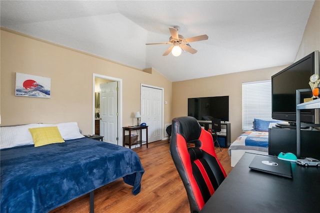 bedroom with a ceiling fan, light wood-style floors, and vaulted ceiling