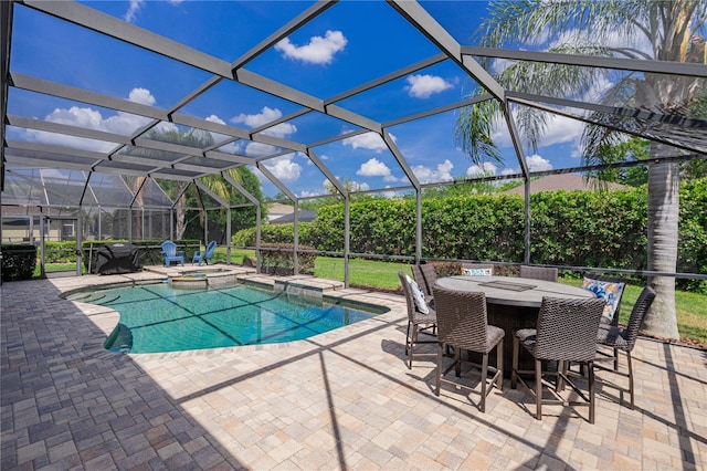 view of pool featuring a pool with connected hot tub, glass enclosure, and a patio area