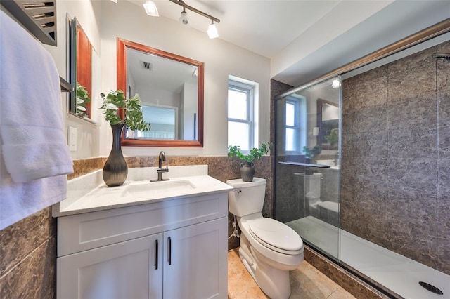 full bath with tile walls, visible vents, toilet, vanity, and a stall shower