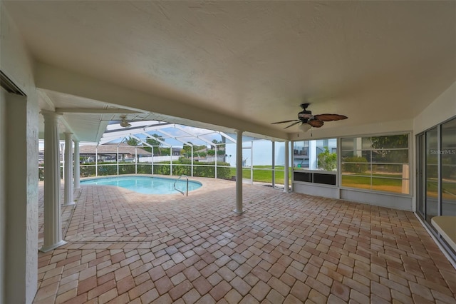 outdoor pool with a lanai, a patio, and a ceiling fan