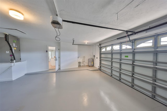 garage with electric water heater, baseboards, a sink, a garage door opener, and heating unit