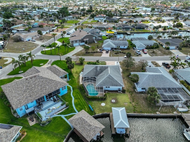 birds eye view of property featuring a residential view and a water view