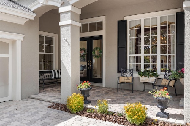 14817 Tudor Chase Dr, Tampa, FL 33626 - property entrance featuring stucco siding, covered porch, and french doors