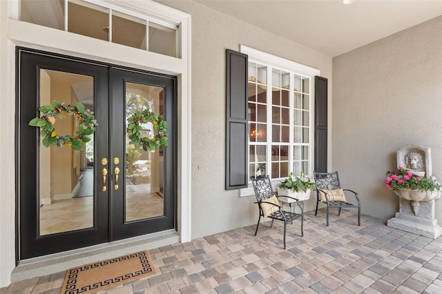14817 Tudor Chase Dr, Tampa, FL 33626 - doorway to property with french doors and stucco siding