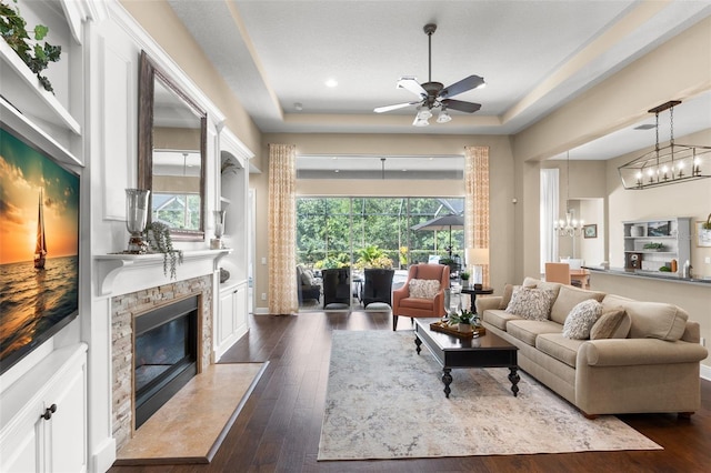 14817 Tudor Chase Dr, Tampa, FL 33626 - living area with a premium fireplace, a chandelier, a raised ceiling, dark wood finished floors, and recessed lighting