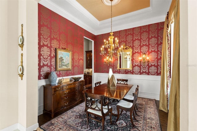 14817 Tudor Chase Dr, Tampa, FL 33626 - dining area with wainscoting, dark wood-type flooring, a chandelier, ornamental molding, and wallpapered walls