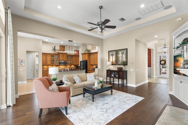 14817 Tudor Chase Dr, Tampa, FL 33626 - living room featuring a raised ceiling, recessed lighting, dark wood-style flooring, and ceiling fan