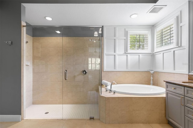 14817 Tudor Chase Dr, Tampa, FL 33626 - bathroom featuring vanity, a garden tub, a stall shower, tile patterned flooring, and recessed lighting