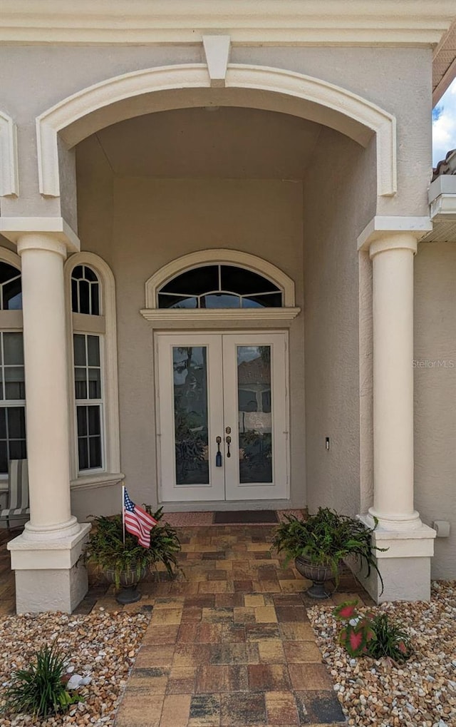 doorway to property with stucco siding and french doors