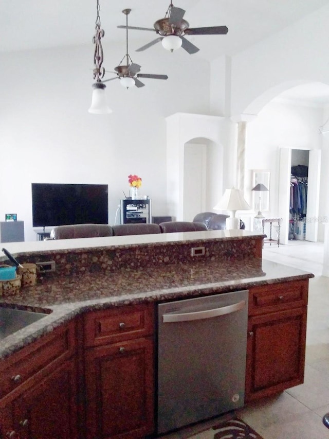 kitchen featuring dishwasher, a ceiling fan, arched walkways, reddish brown cabinets, and open floor plan