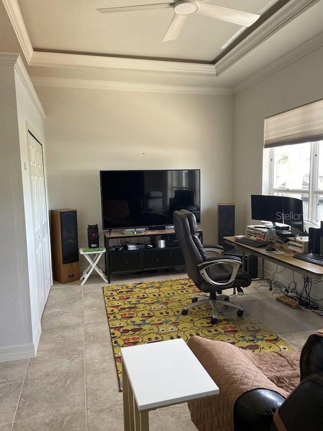 office with a tray ceiling, crown molding, tile patterned floors, and a ceiling fan