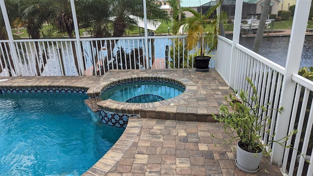 view of pool featuring a water view and a pool with connected hot tub