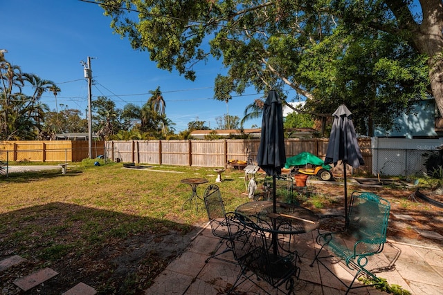 4126 Carson St NE, Saint Petersburg, FL 33703 - view of yard featuring a fenced backyard, outdoor dining area, and a patio area
