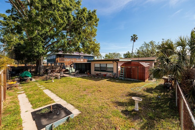 4126 Carson St NE, Saint Petersburg, FL 33703 - view of yard featuring a storage shed, fence, and an outbuilding