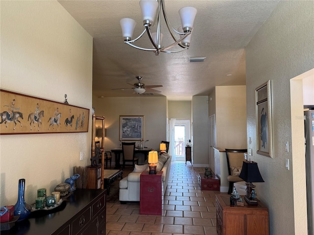 3011/2 Shore Dr E, Oldsmar, FL 34677 - living area featuring a textured ceiling, tile patterned flooring, ceiling fan, a chandelier, and a textured wall