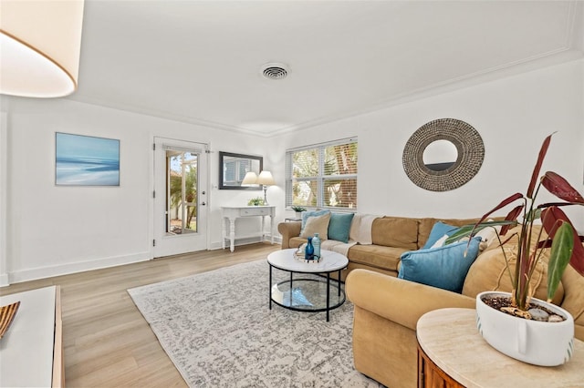 living area featuring baseboards, visible vents, and light wood-style flooring