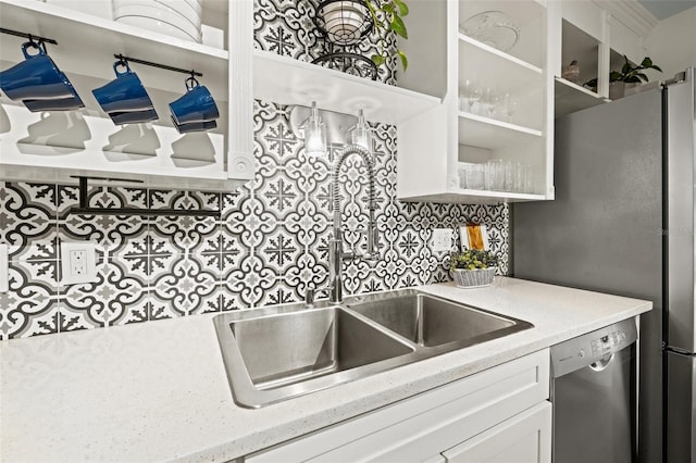 kitchen with dishwasher, glass insert cabinets, white cabinetry, a sink, and backsplash