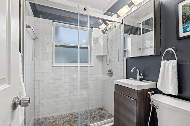 full bath with a shower stall, toilet, vanity, and ornamental molding