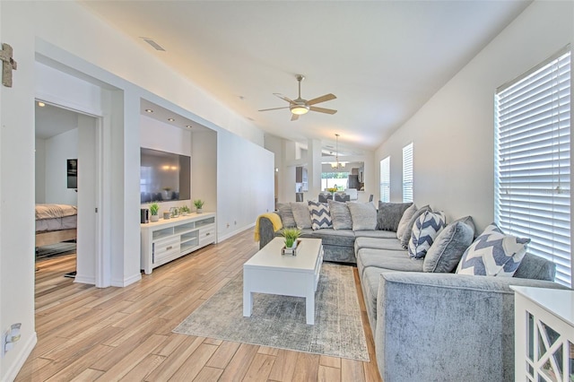 1666 Meadow Oak Ln, Tarpon Springs, FL 34689 - living area featuring ceiling fan, light wood-style flooring, and vaulted ceiling