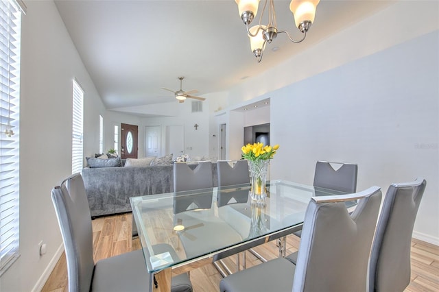 1666 Meadow Oak Ln, Tarpon Springs, FL 34689 - dining area with ceiling fan, a chandelier, lofted ceiling, and light wood finished floors