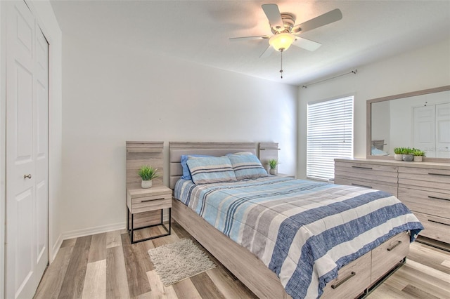 1666 Meadow Oak Ln, Tarpon Springs, FL 34689 - bedroom with light wood-type flooring and ceiling fan