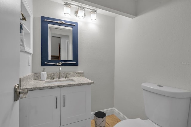 337 Rex Pl Unit E, Madeira Beach, FL 33708 - half bathroom with toilet, vanity, and baseboards