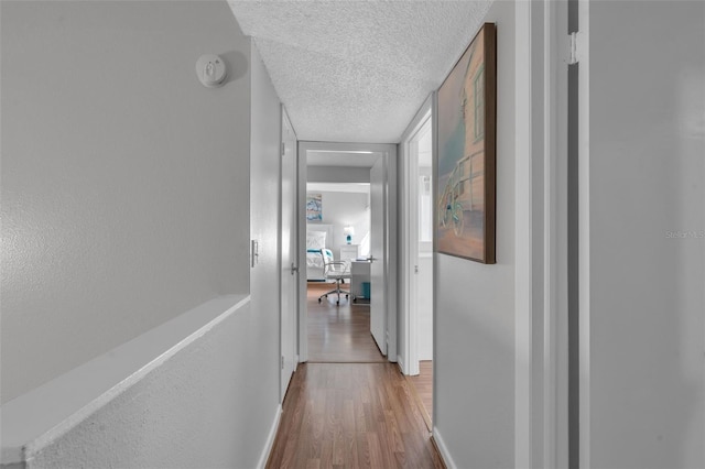 337 Rex Pl Unit E, Madeira Beach, FL 33708 - corridor featuring wood finished floors, a textured ceiling, and baseboards
