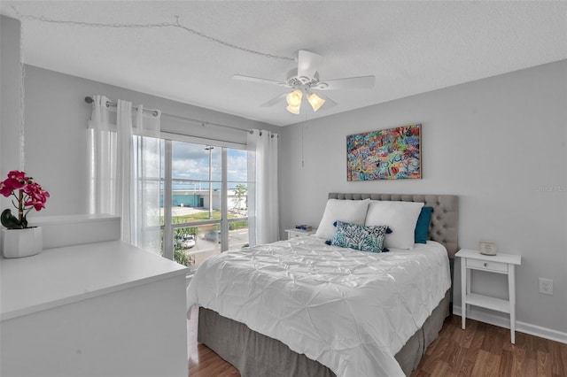 337 Rex Pl Unit E, Madeira Beach, FL 33708 - bedroom with wood finished floors, a ceiling fan, baseboards, and a textured ceiling