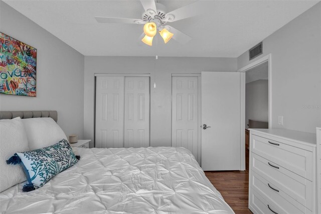337 Rex Pl Unit E, Madeira Beach, FL 33708 - bedroom featuring dark wood finished floors, a ceiling fan, and a closet