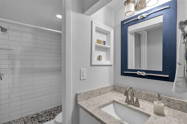 337 Rex Pl Unit E, Madeira Beach, FL 33708 - full bathroom with a shower stall, vanity, toilet, and a textured wall