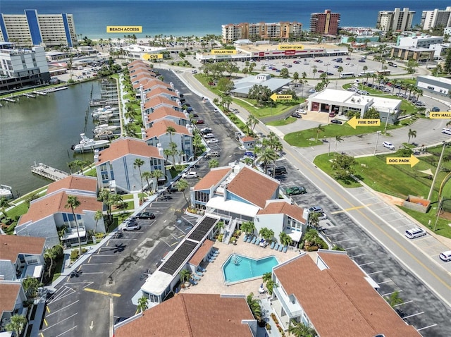 337 Rex Pl Unit E, Madeira Beach, FL 33708 - aerial view of property's location with a nearby body of water, a pool area, and nearby urban area