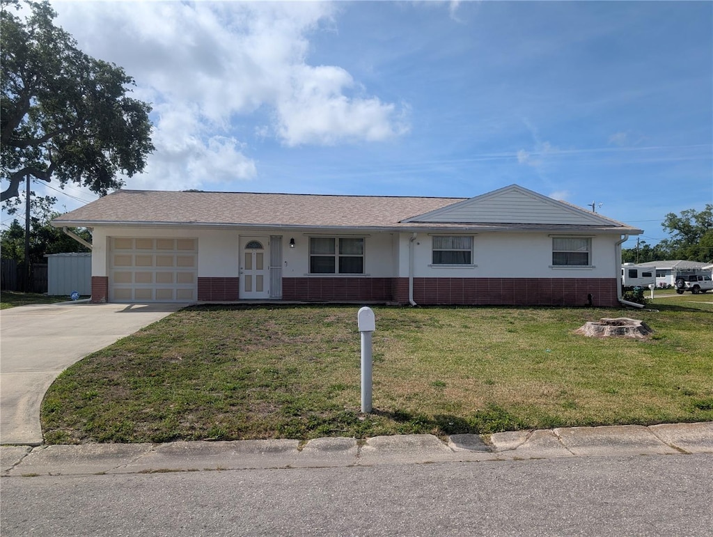10968 105th Ave, Largo, FL 33778 - single story home with an attached garage, concrete driveway, a front yard, brick siding, and a shingled roof