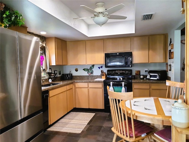 8810 41st St N, Pinellas Park, FL 33782 - kitchen featuring black appliances, light brown cabinetry, a tray ceiling, a ceiling fan, and dark countertops