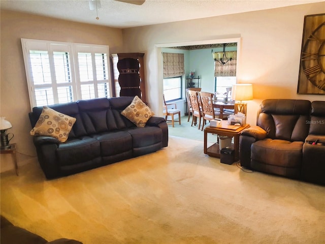 8810 41st St N, Pinellas Park, FL 33782 - carpeted living area with a ceiling fan, a chandelier, and a textured ceiling