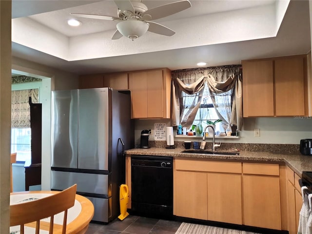 8810 41st St N, Pinellas Park, FL 33782 - kitchen with freestanding refrigerator, dishwasher, a tray ceiling, dark tile patterned flooring, and a ceiling fan