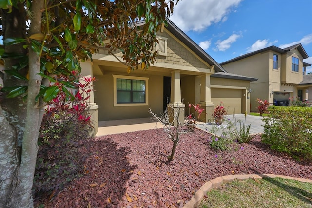 838 Vino Verde Cir, Brandon, FL 33511 - craftsman-style house with an attached garage, covered porch, stucco siding, and concrete driveway