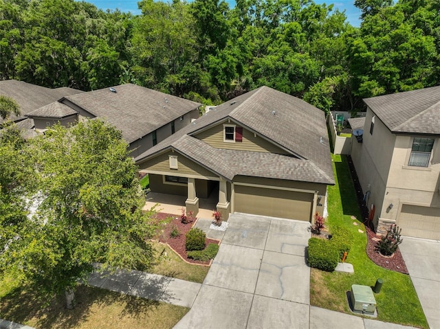 838 Vino Verde Cir, Brandon, FL 33511 - craftsman-style house with a shingled roof, driveway, and stucco siding