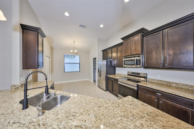 838 Vino Verde Cir, Brandon, FL 33511 - kitchen featuring light tile patterned floors, dark brown cabinets, visible vents, appliances with stainless steel finishes, and a sink